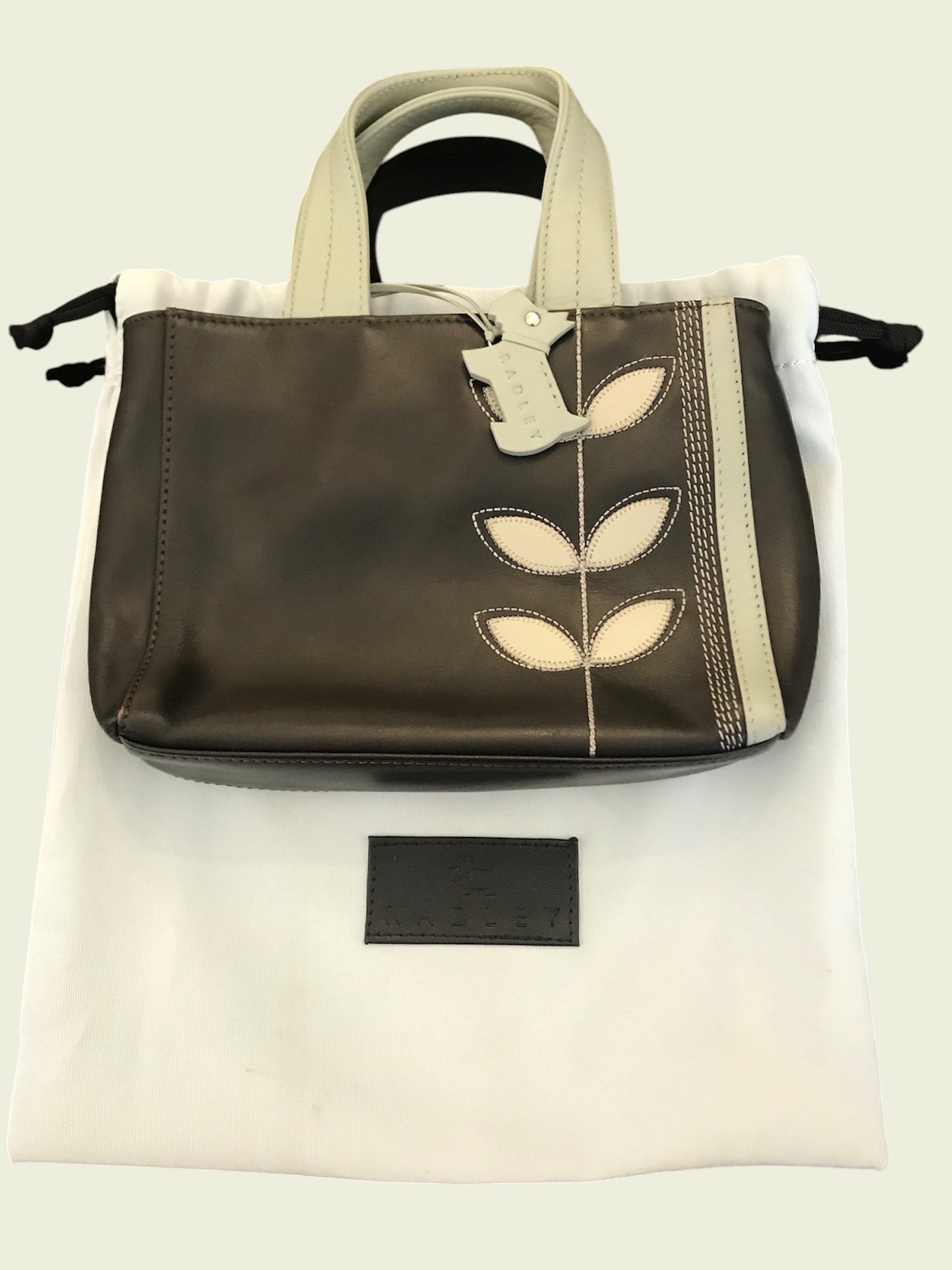 Handbag with leaf design on a white background
