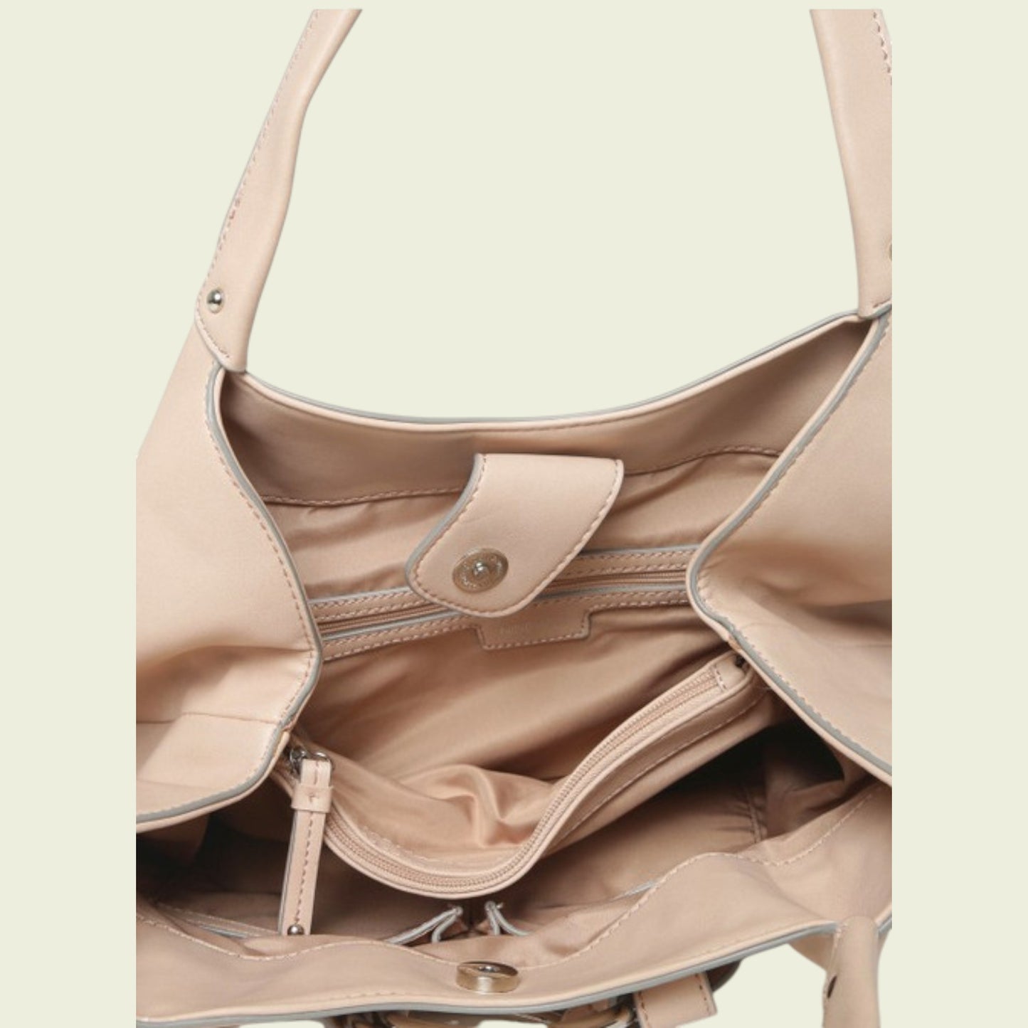 Close-up of inside of pink handbag with a light background