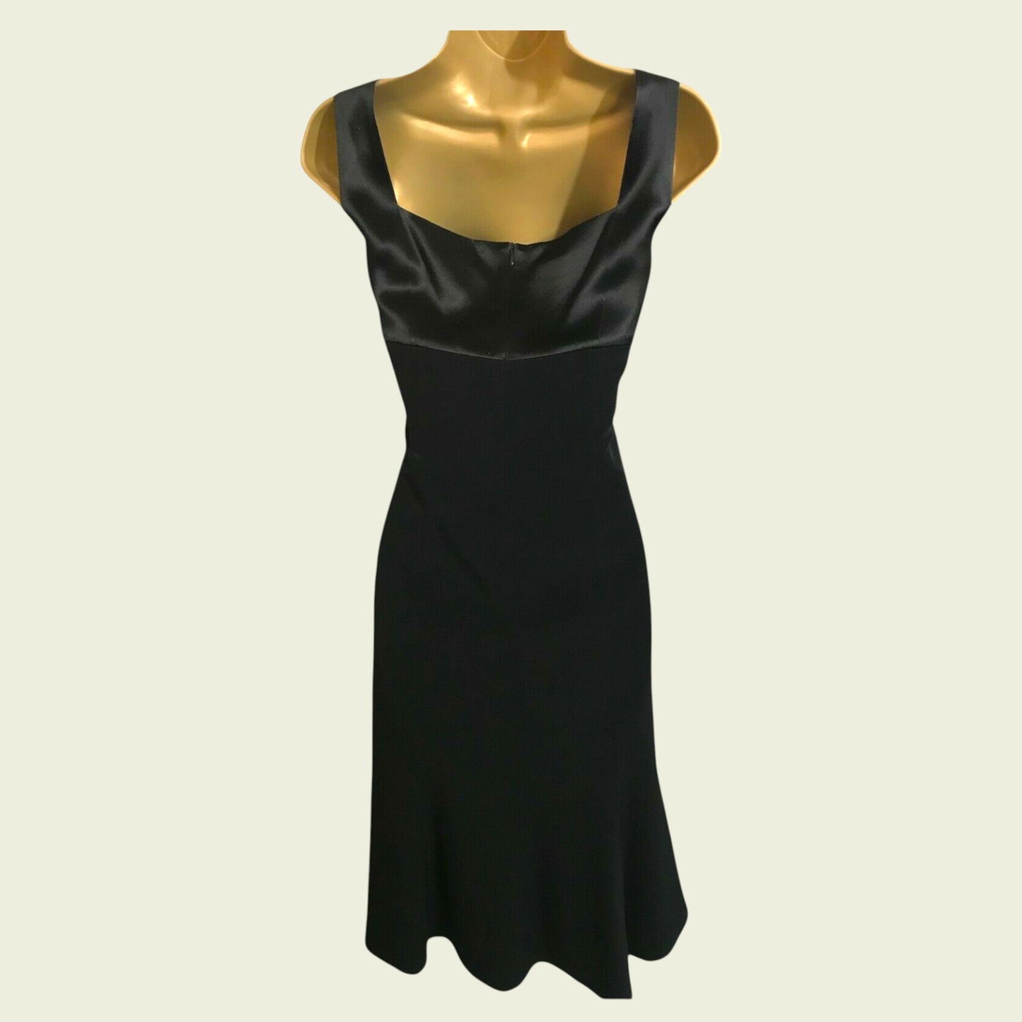 Black dress on a mannequin against a white background