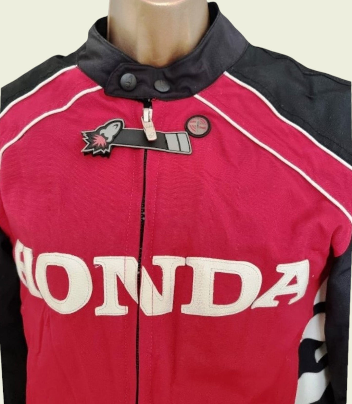 Red and black motorcycle jacket with Honda branding on a mannequin.