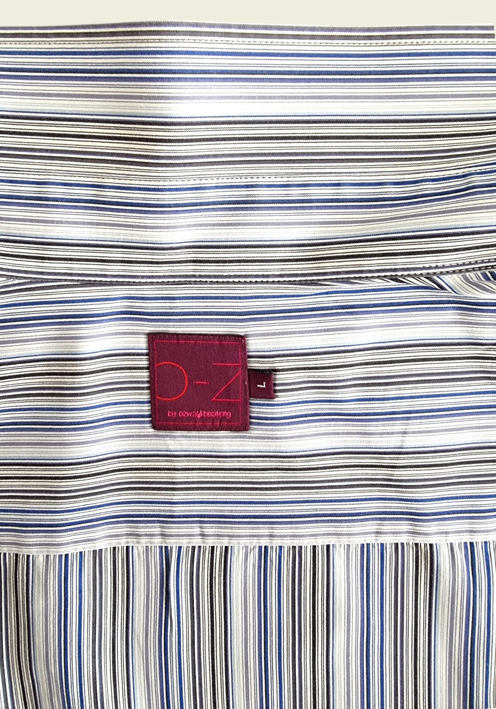 Striped fabric with a red label featuring 'O -Z' branding.