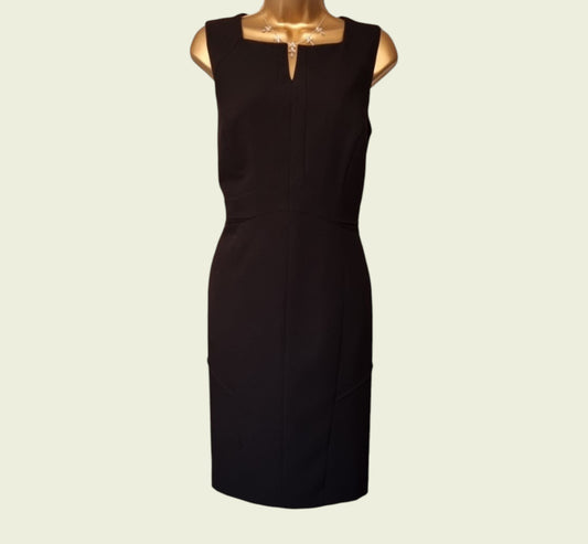 Black dress on a mannequin against a beige background