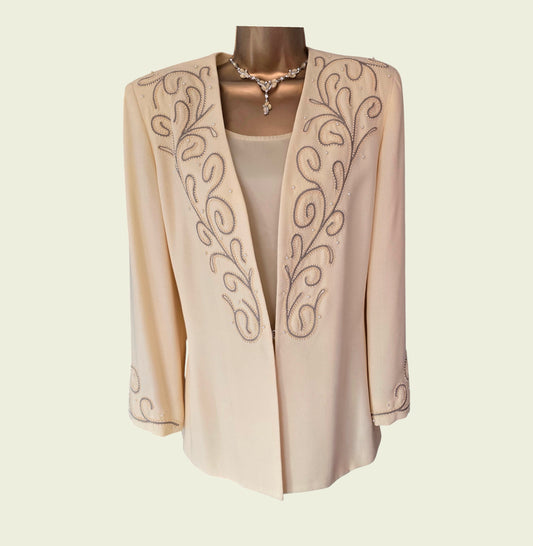 Yellow embroidered jacket on a mannequin against a beige background