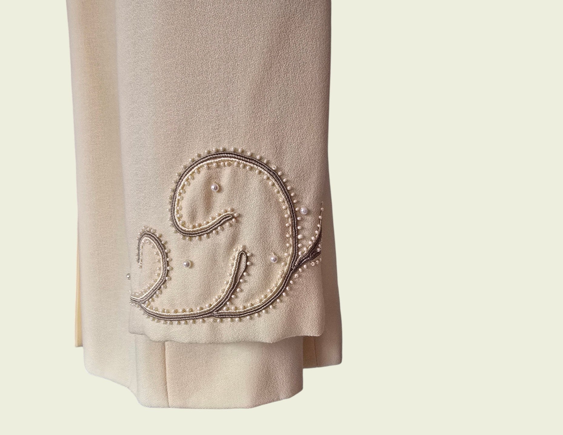 Yellow fabric with decorative stitching on a beige background