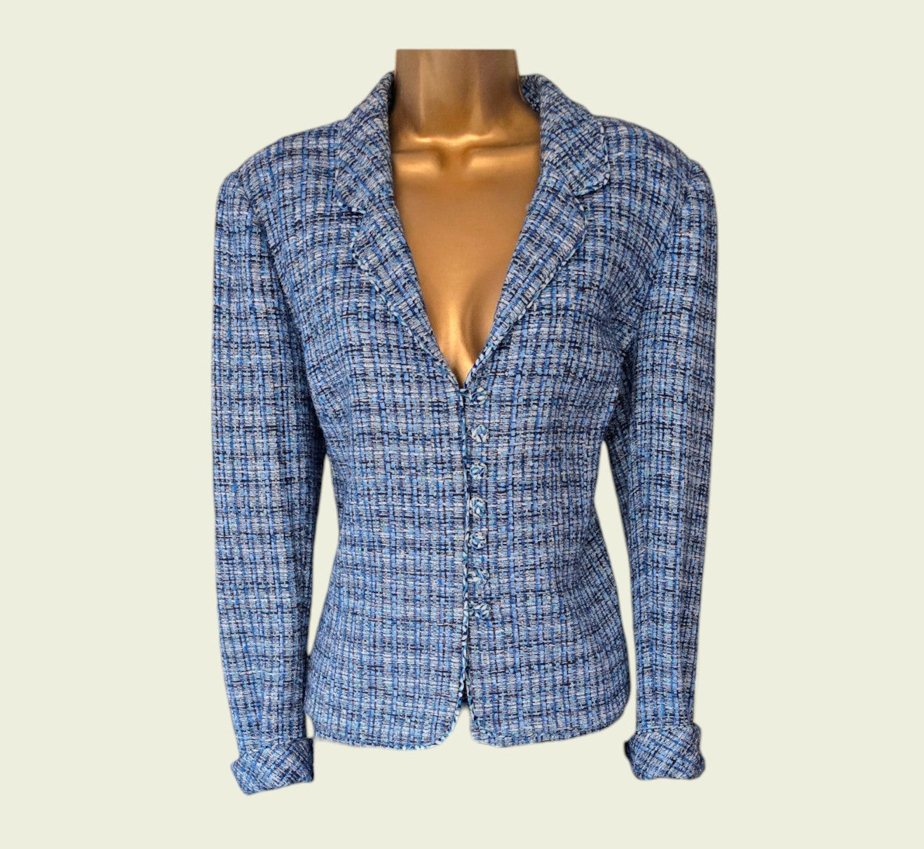 Blue checkered blazer on a mannequin against a beige background