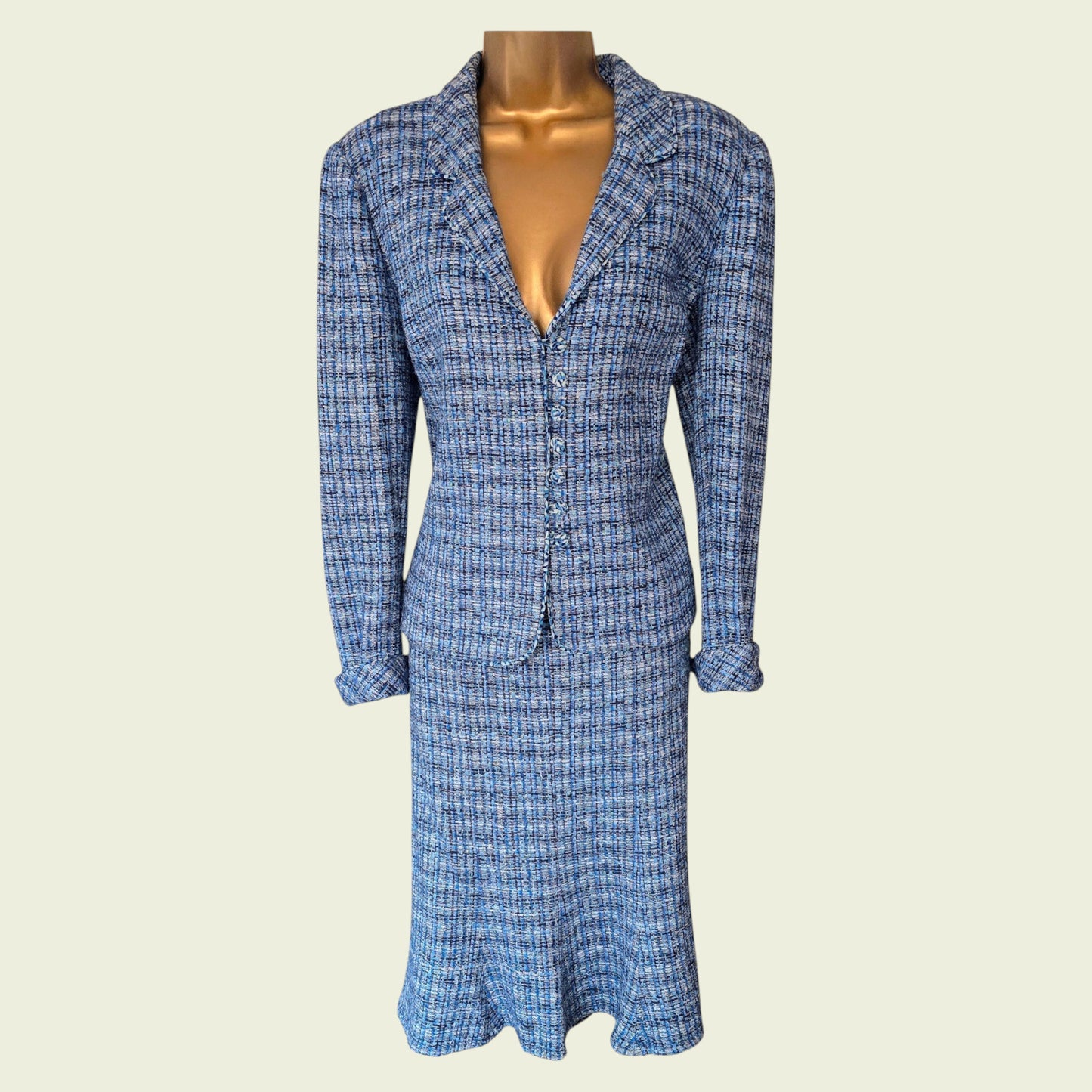 Blue plaid skirt and jacket on a mannequin against a beige background