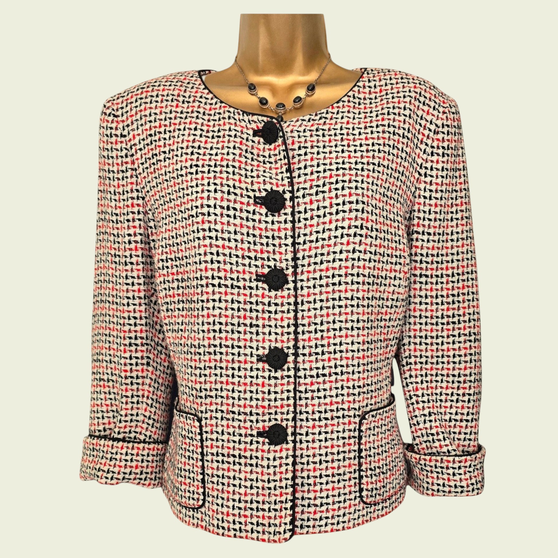 Jacket with black buttons on a mannequin against a beige background