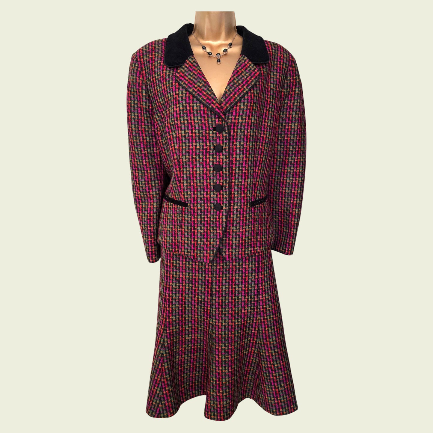 Plaid suit with black collar on a mannequin against a white background