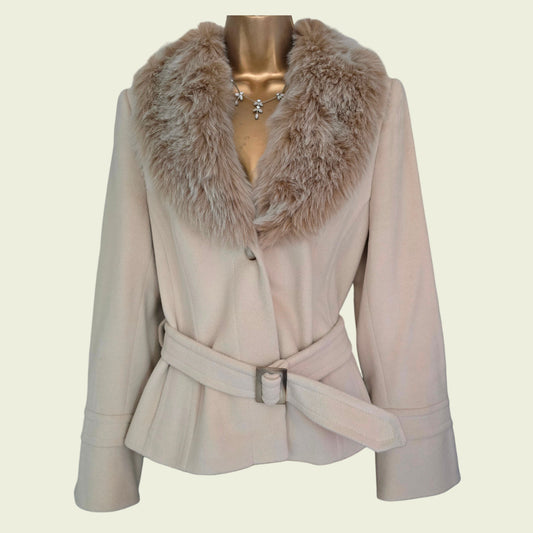 Beige coat with fur collar on a mannequin against a beige background