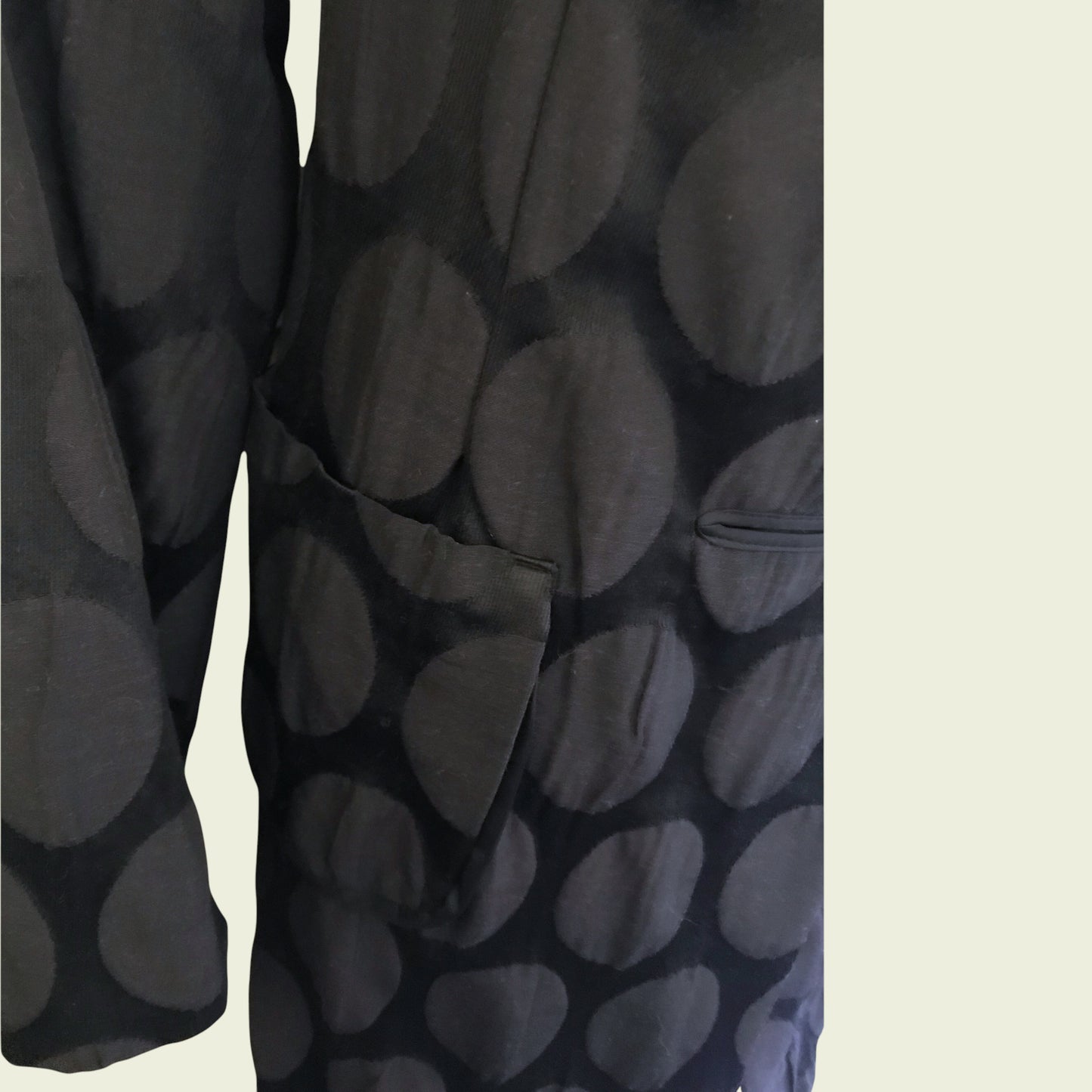 Black patterned fabric on a beige background