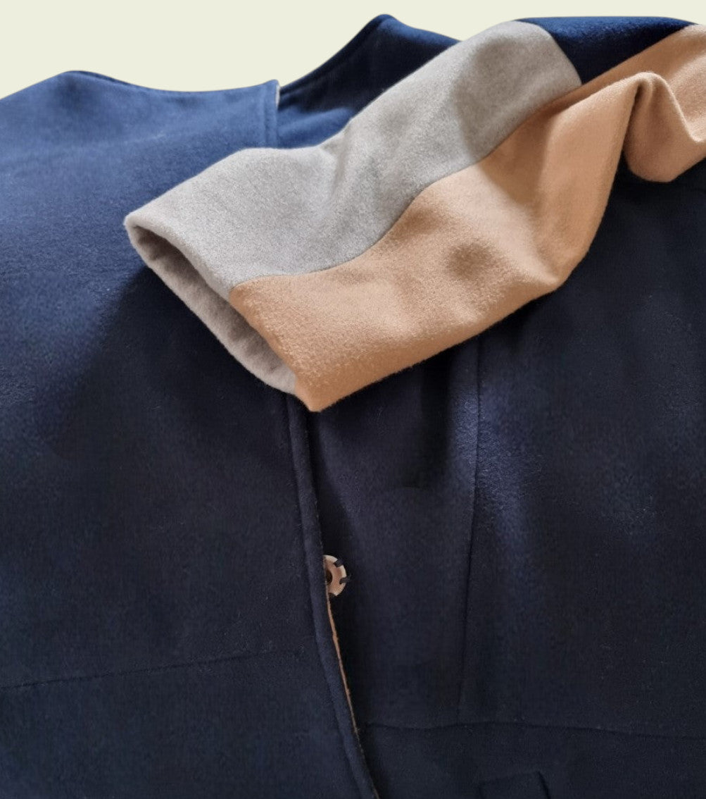 Navy jacket with color-blocked sleeve featuring beige, gray, and blue.