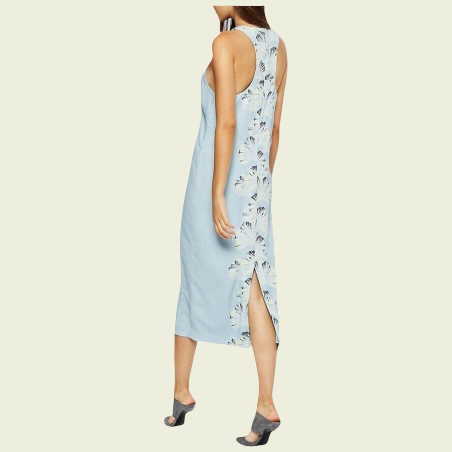 Light blue sleeveless dress with floral pattern on a beige background