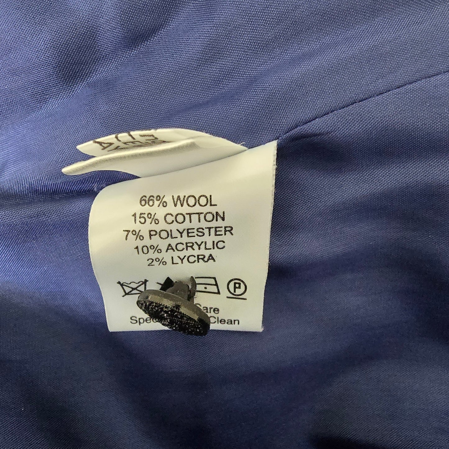 Clothing label on a blue fabric background with fabric texture