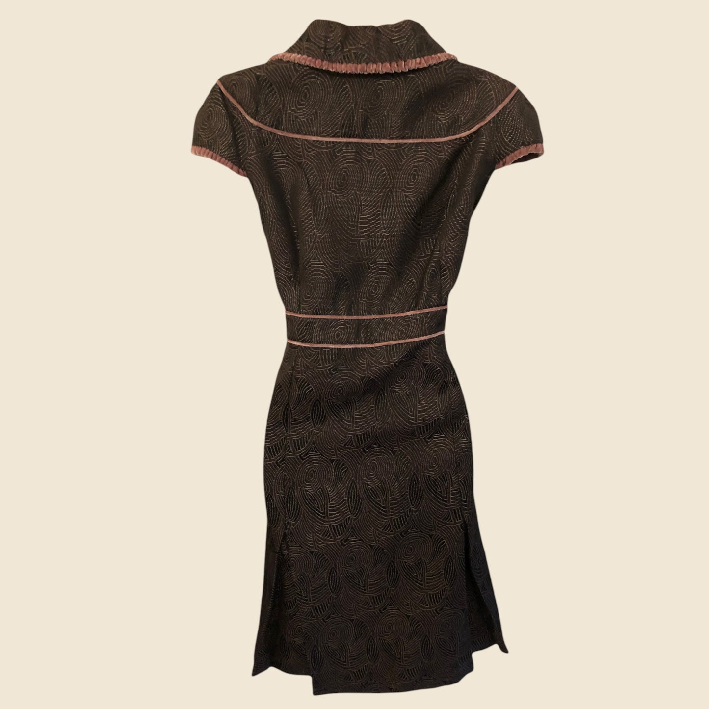Dark brown dress with pattern on a beige background