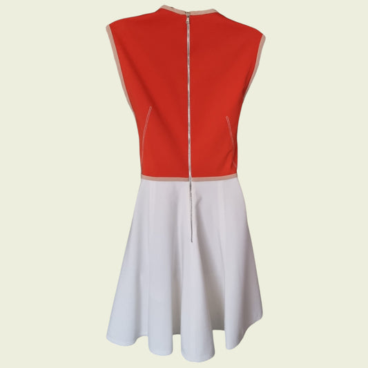 Red and white dress with a zipper on a beige background
