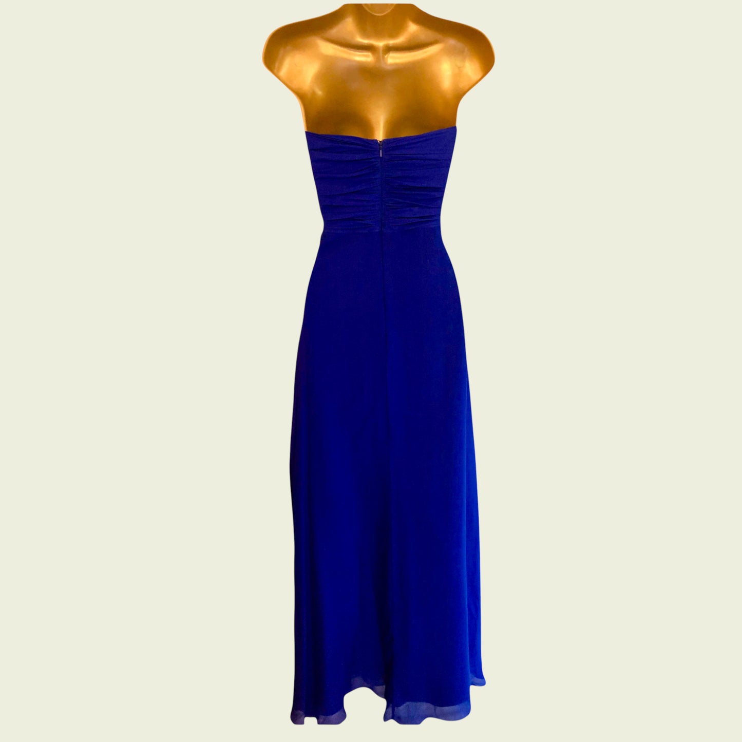 Blue evening gown on a mannequin against a beige background