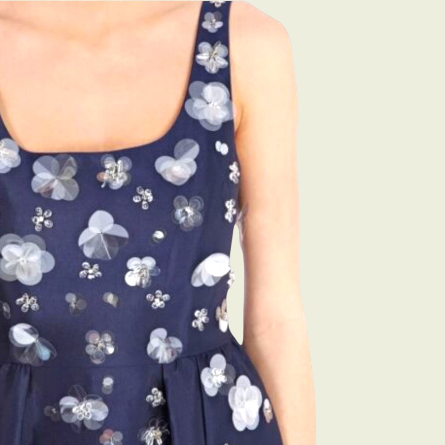 Navy blue dress with white floral patterns on a plain background