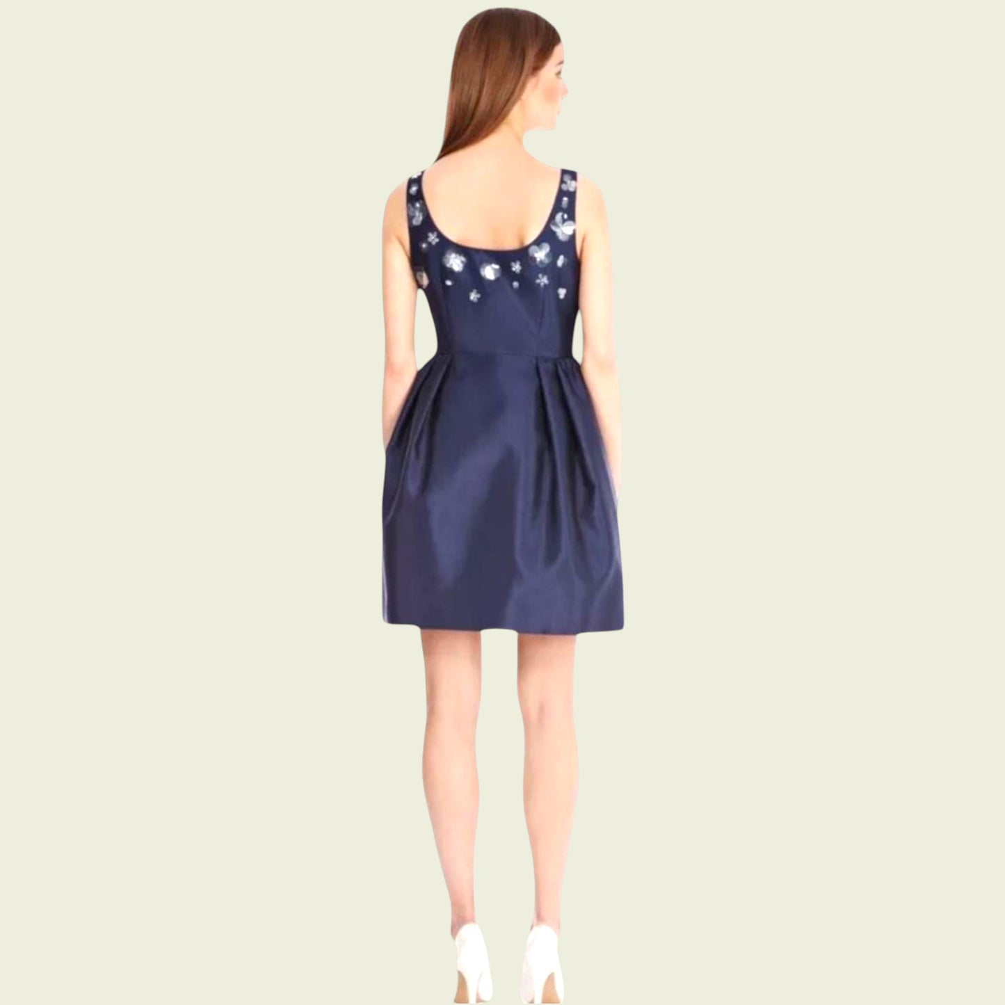 Navy blue dress with floral embellishments on a beige background
