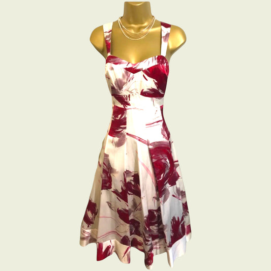 Red and white floral dress on a mannequin against a light background