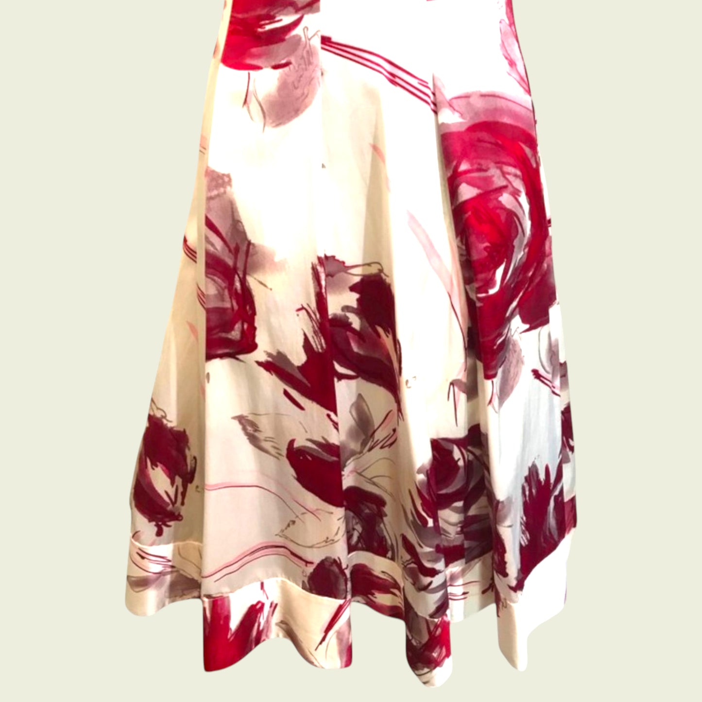 Floral patterned dress with red and white colors on a light background