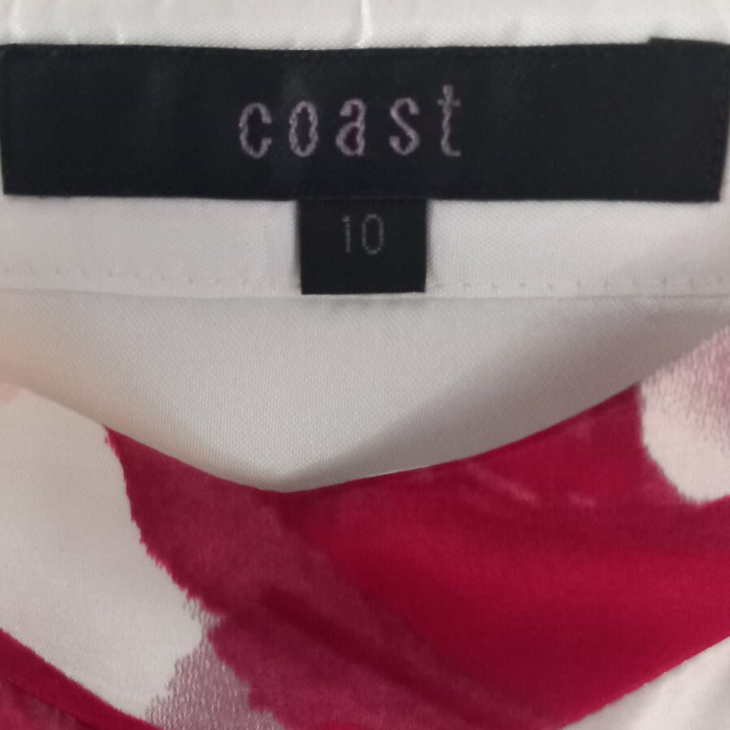 Close-up of a clothing label with 'coast' brand name and size '10'.