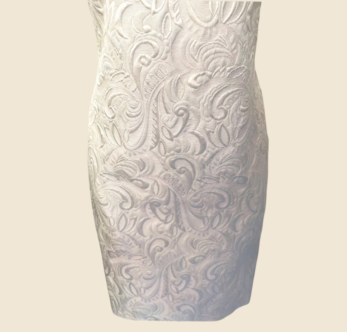 Dress with intricate patterns on a beige background