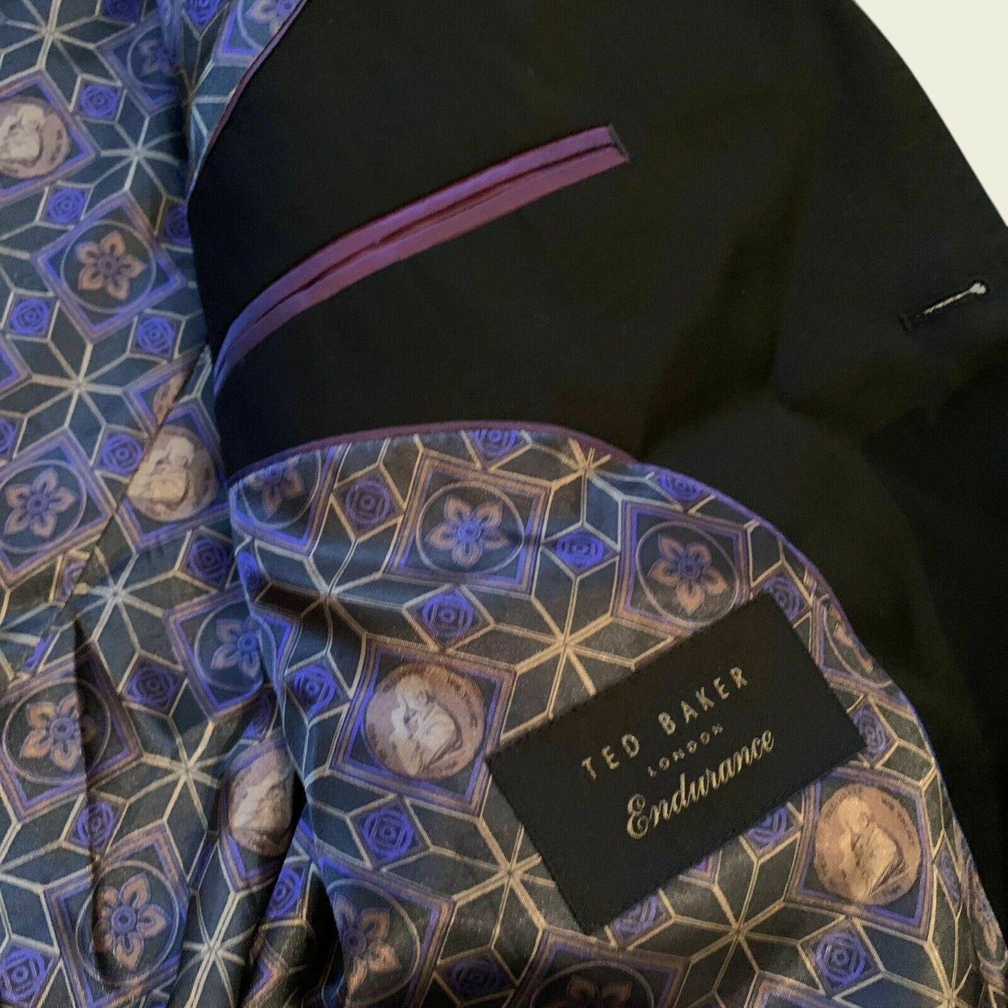 Black suit jacket with a patterned lining and Ted Baker label.