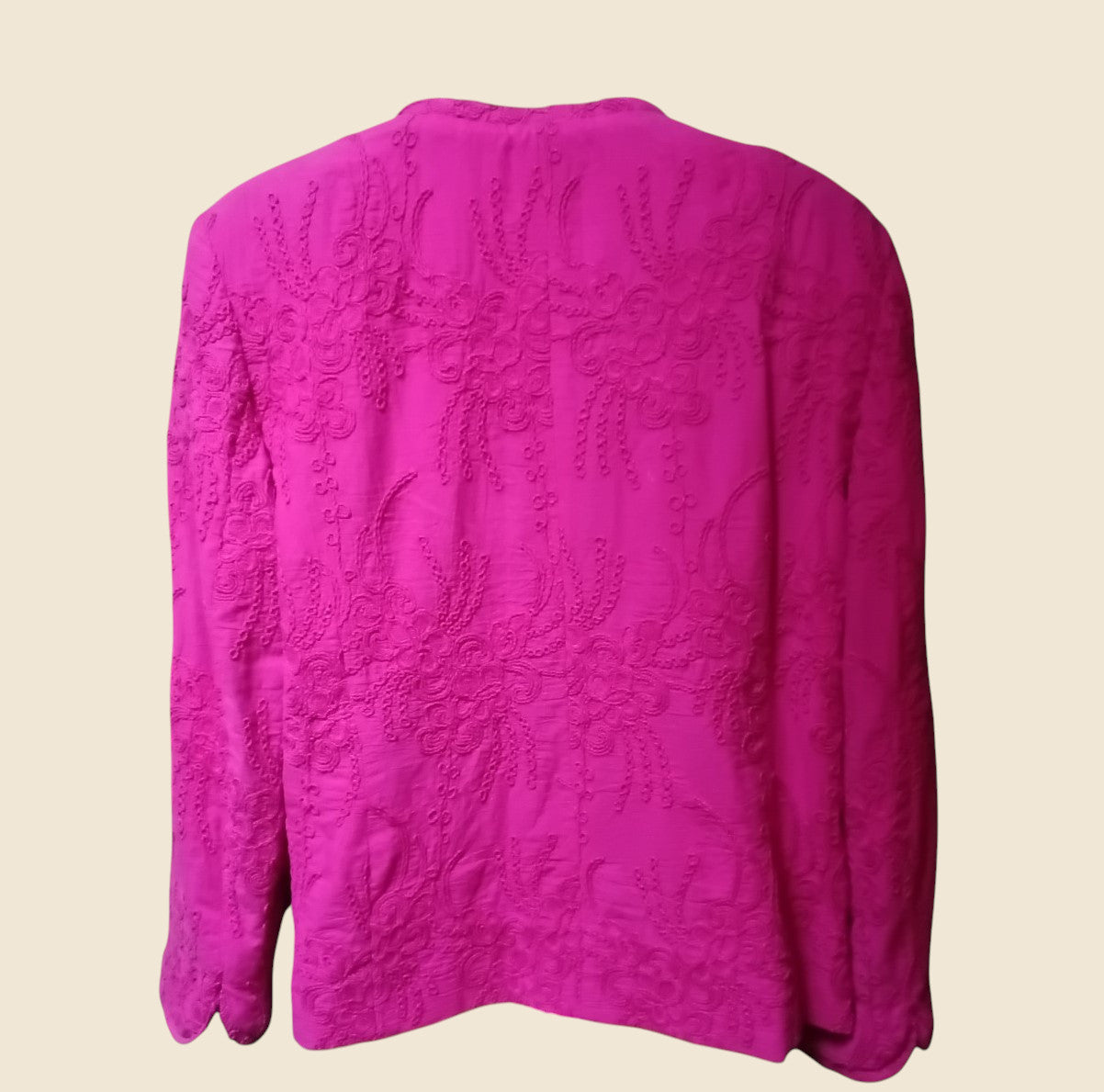 Pink textured blouse on a beige background