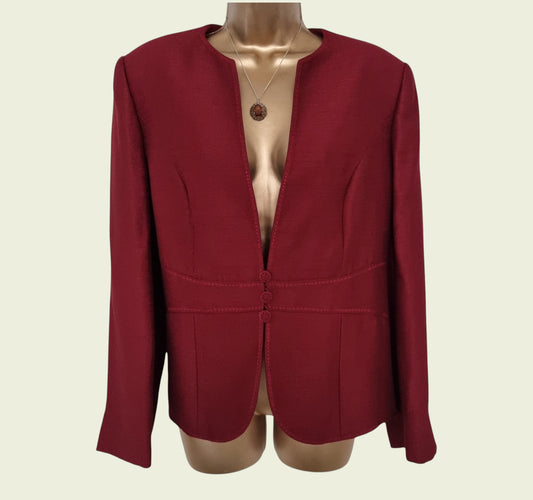Red blazer on a mannequin against a beige background