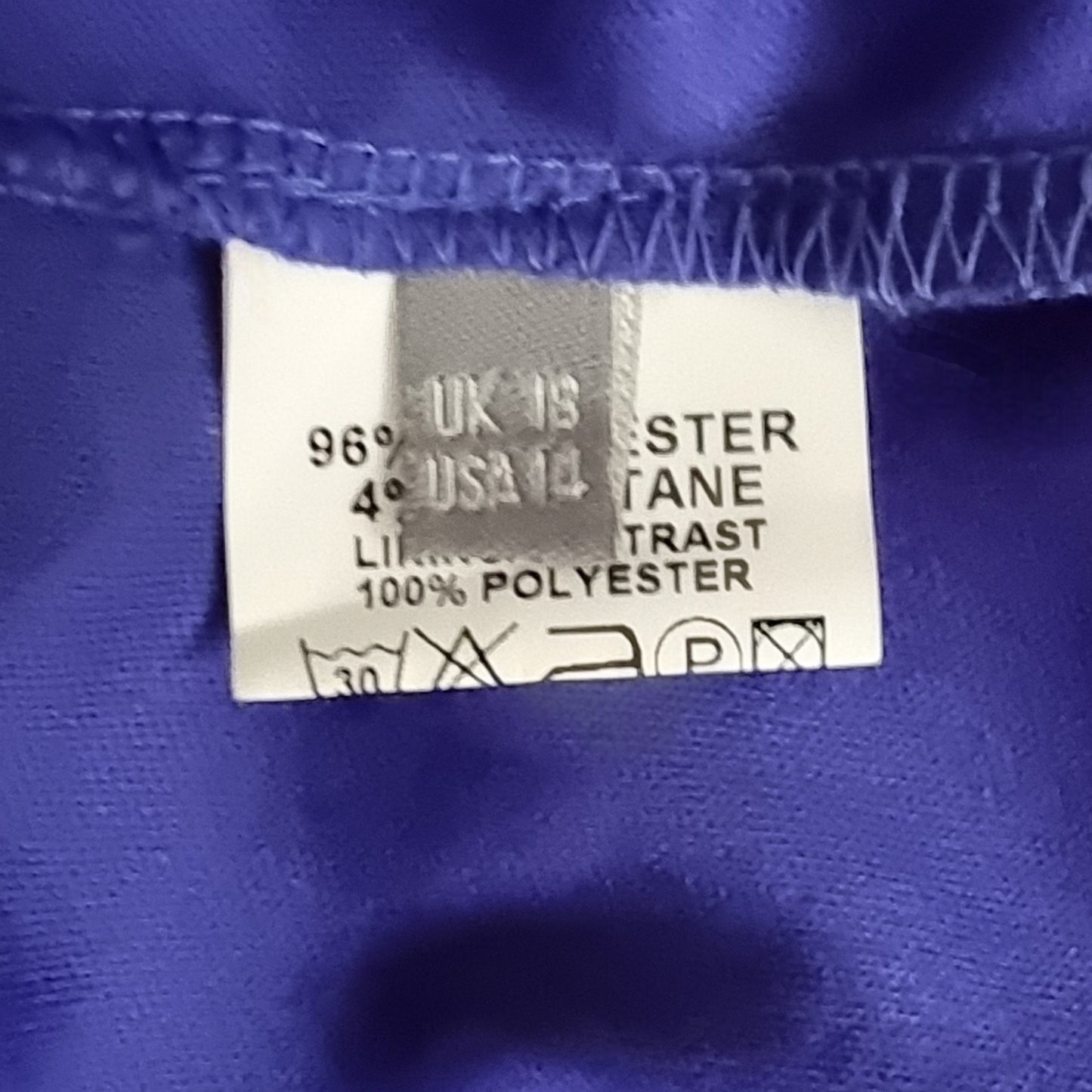 Fabric tag with material information on a blue fabric background