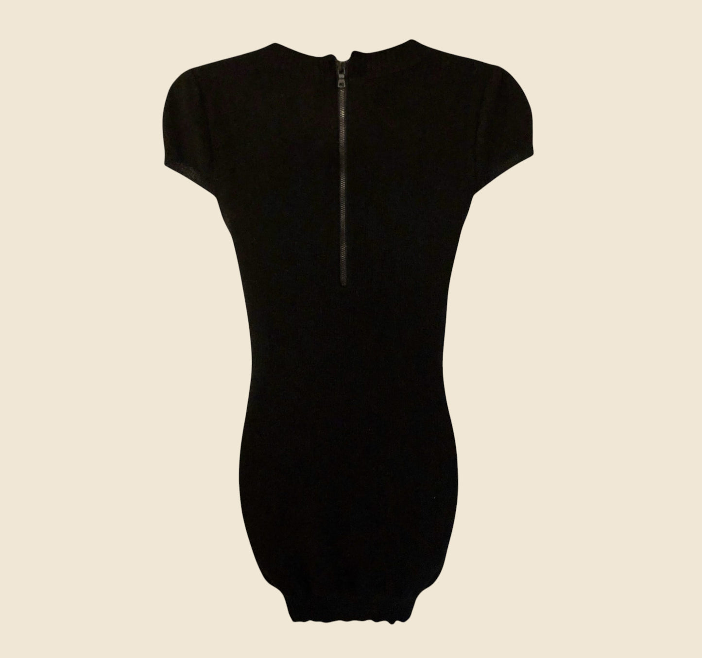 Black dress with short sleeves on a beige background