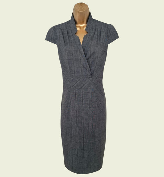 Gray dress on a mannequin against a beige background