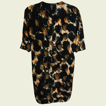 Black dress with abstract orange and beige pattern on a light gray background