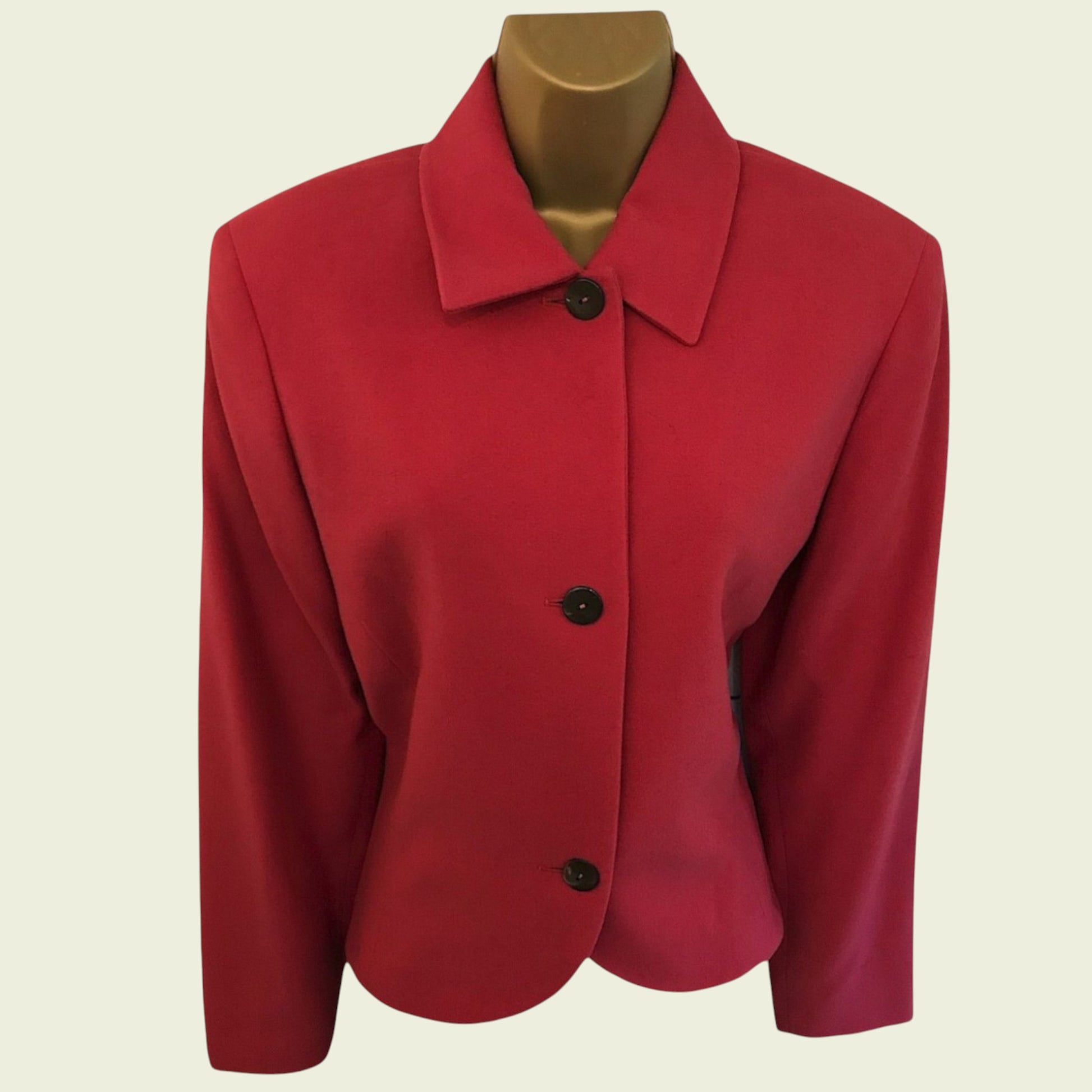 Red jacket on a mannequin against a beige background