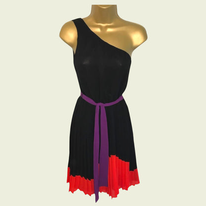 Black dress with purple belt and red bottom on a mannequin against a beige background