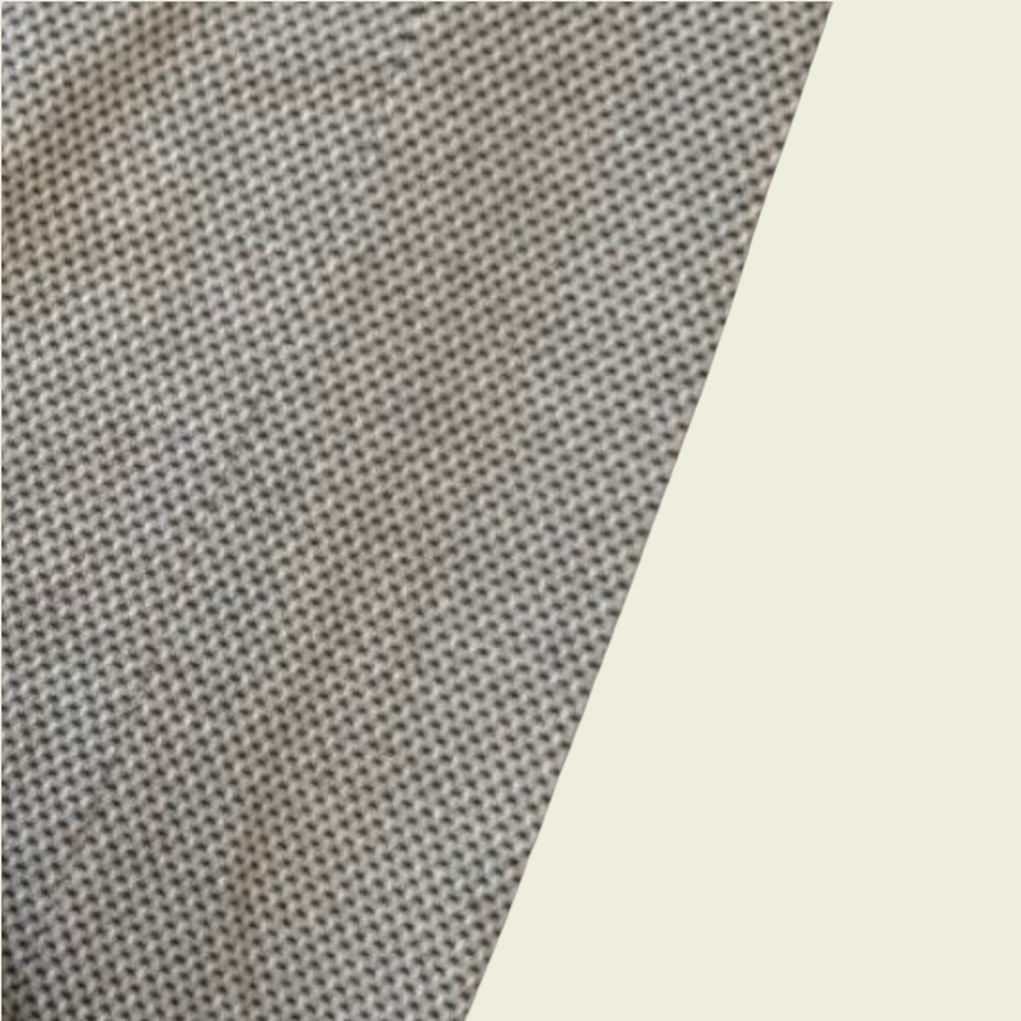 Close-up of textured gray fabric with a light beige background