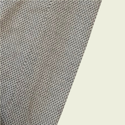 Close-up of textured gray fabric with a light beige background