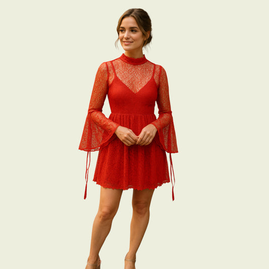 Woman wearing a red lace dress on a beige background