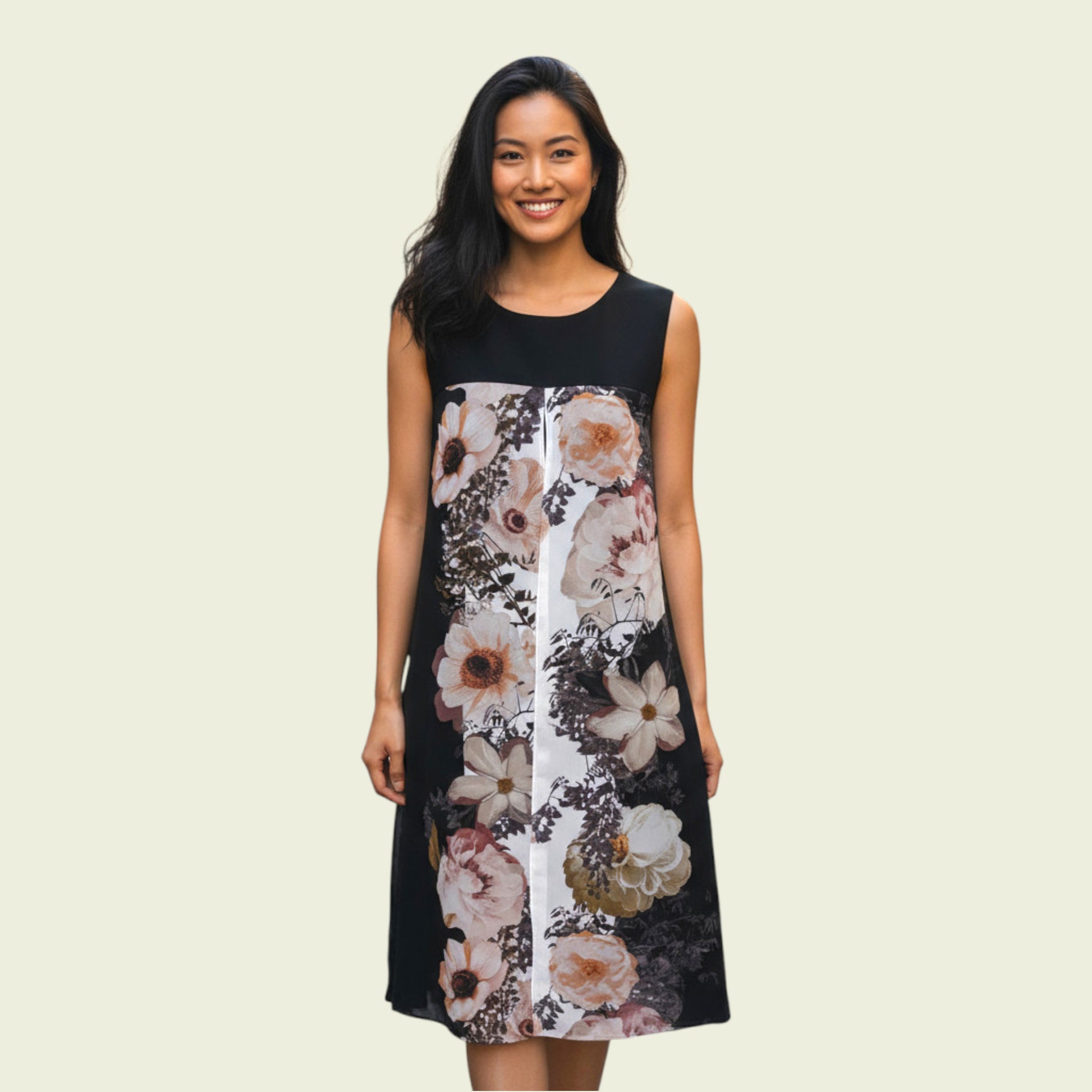 Woman wearing a black sleeveless dress with floral pattern on a beige background