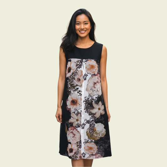 Woman wearing a black sleeveless dress with floral pattern on a beige background