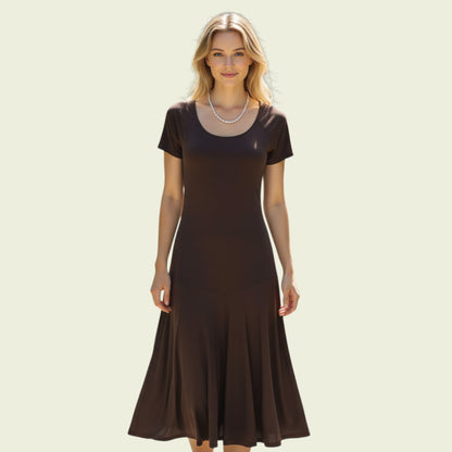 Woman wearing a brown dress on a beige background