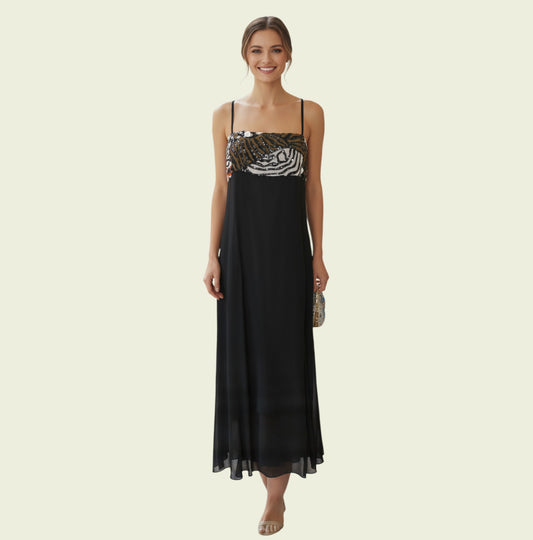 Woman wearing a black evening gown with a patterned top on a beige background