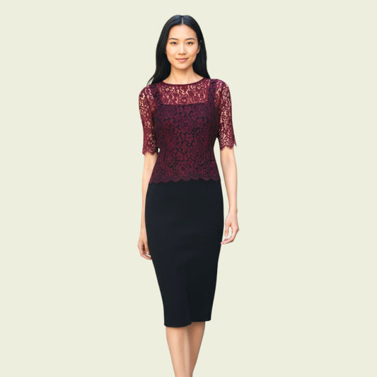 Woman wearing a dress with red lace top and black skirt on a beige background