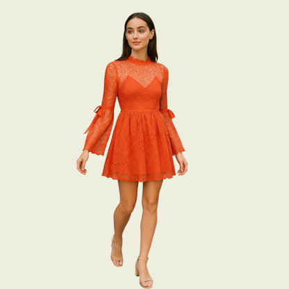 Woman wearing an orange lace dress on a beige background