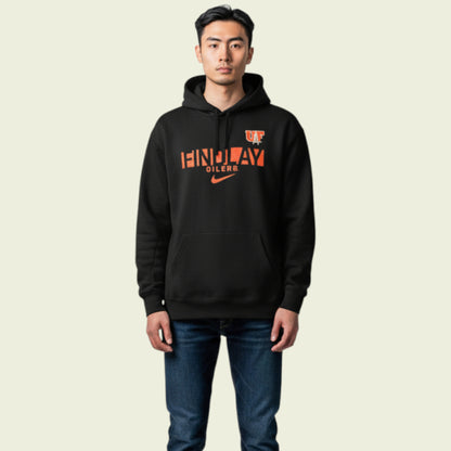 Person wearing a black hoodie with orange text on a beige background