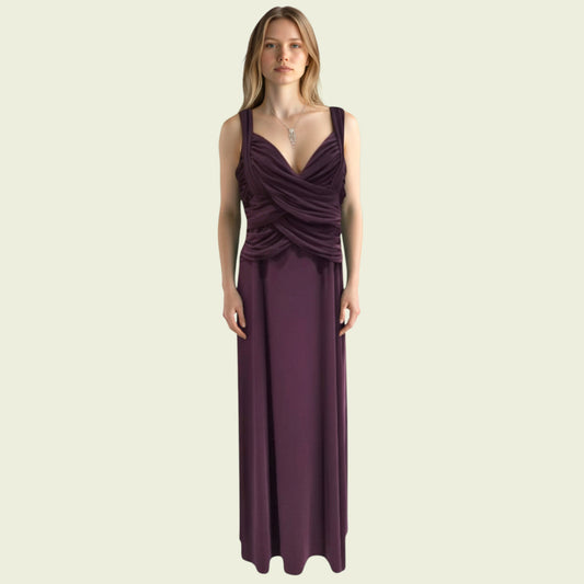 Model wearing a long purple special occasions dress on a beige background