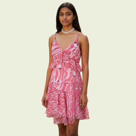 Model wearing a pink summer mini dress on beige background