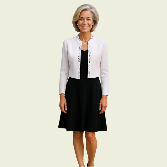 Woman wearing a lilac jacket with and a black dress on a beige background