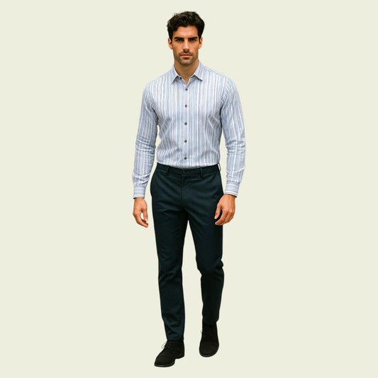 Man wearing a striped shirt and dark pants on a beige background