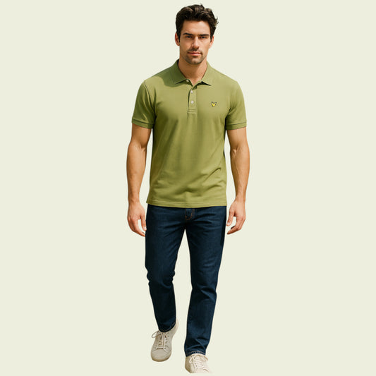 Man wearing a green polo shirt and blue jeans on a beige background